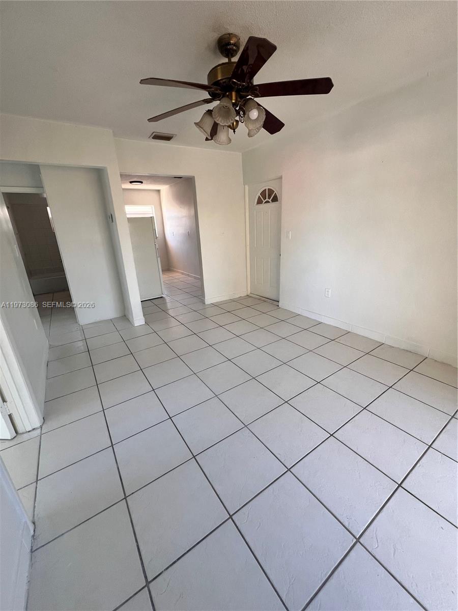 608 Southwest 15th Avenue, Unit 2 Miami, FL 33135 - Photo 4 of 22 a view of an empty room and chandelier fan
