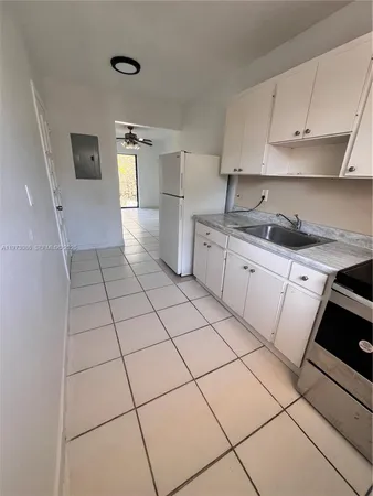 a kitchen with stainless steel appliances a sink and cabinets