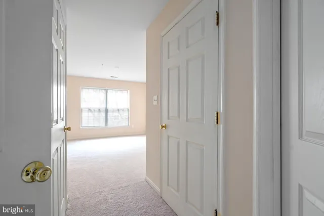 a spacious bedroom with a bed and a window