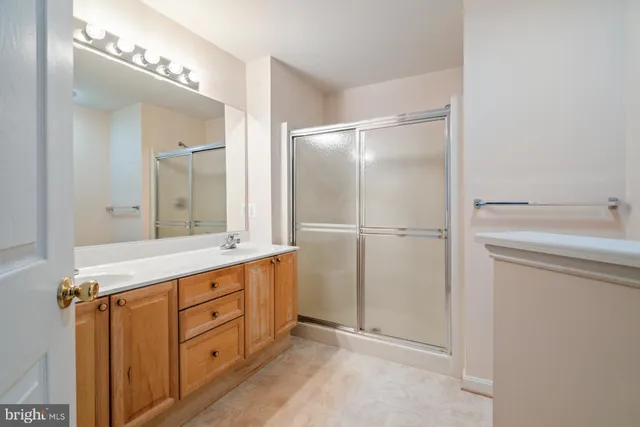 a bathroom with a glass shower door