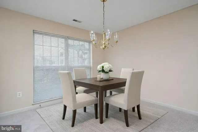 an empty room with chandelier fan