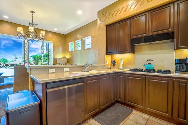 a kitchen with a sink cabinets and window