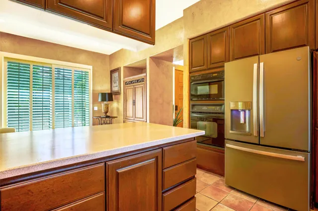a kitchen with a refrigerator and a sink