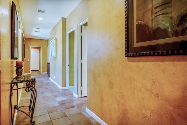 a view of a hallway with wooden shelves