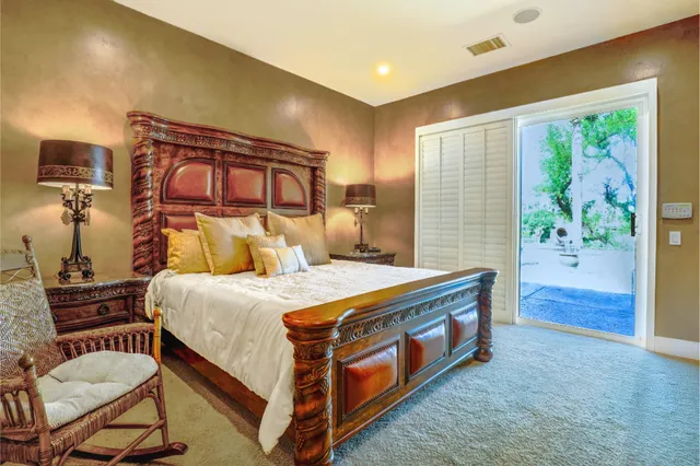 a bed room with a bed and a chair