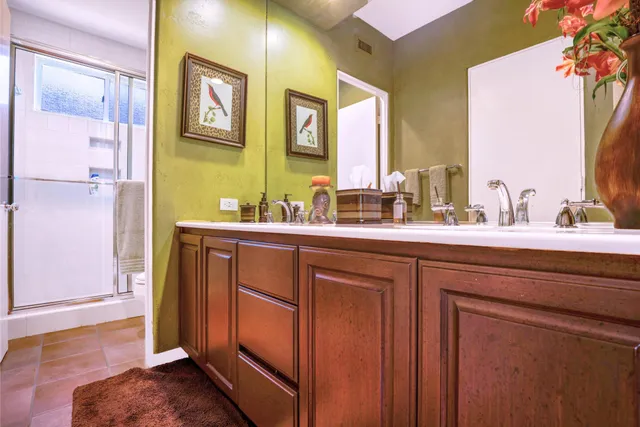 a bathroom with a double vanity sink and a mirror