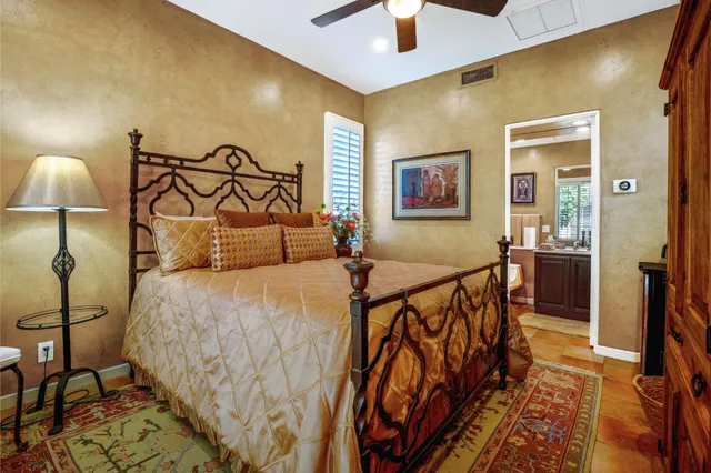 a bedroom with a bed and glass walk in closet