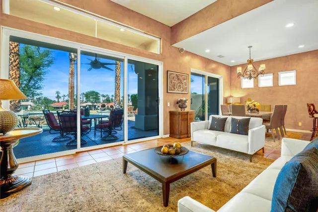 a living room with furniture rug and wooden floor