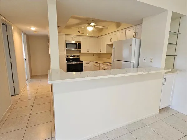 a kitchen with granite countertop a stove and a sink