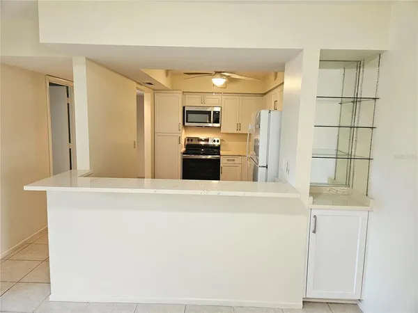 a kitchen with stainless steel appliances a refrigerator sink and microwave