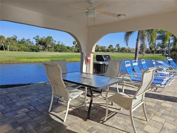 a view of a house with pool and a yard