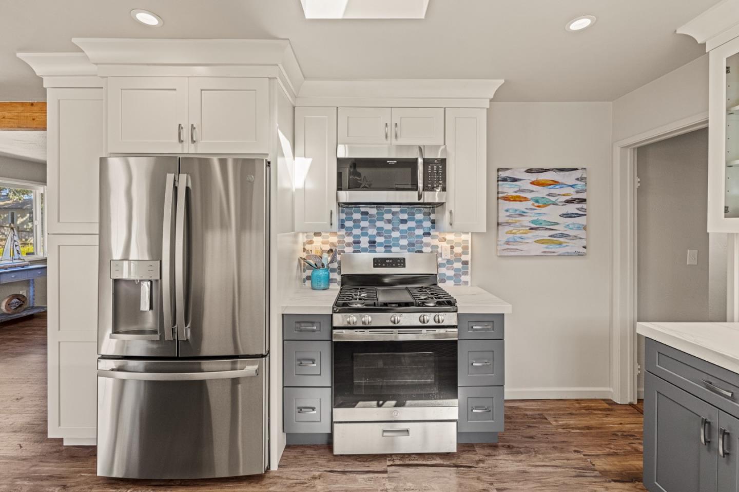 840 Filmore Street Monterey, CA 93940 - Photo 12 of 39 a kitchen with stainless steel appliances a refrigerator a stove and white cabinets