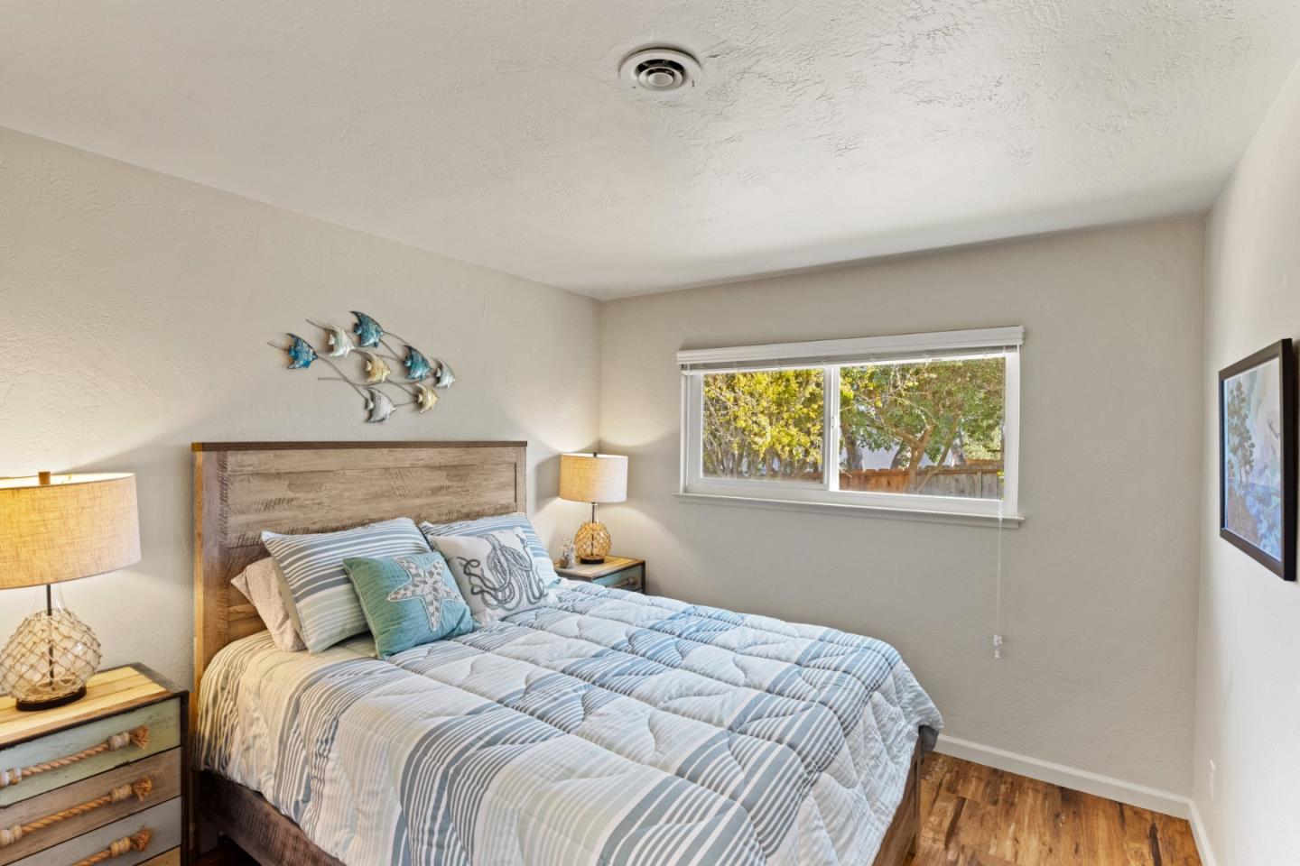 840 Filmore Street Monterey, CA 93940 - Photo 23 of 39 a bedroom with a bed and a window