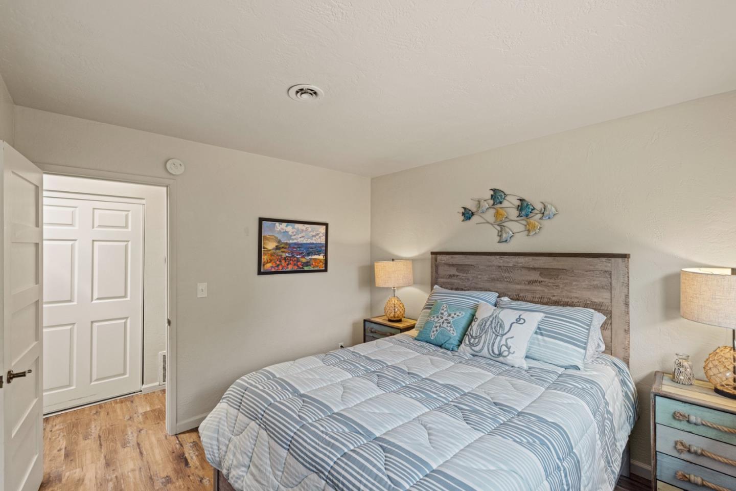 840 Filmore Street Monterey, CA 93940 - Photo 24 of 39 a bedroom with a bed and a lamp on dresser