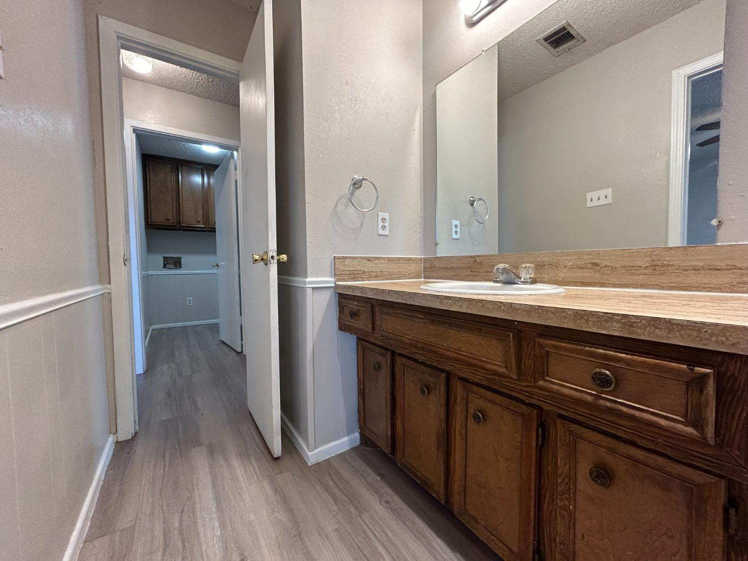 4812 66th Street, Unit B Lubbock, TX 79414 - Photo 6 of 9 a bathroom with a sink and a mirror