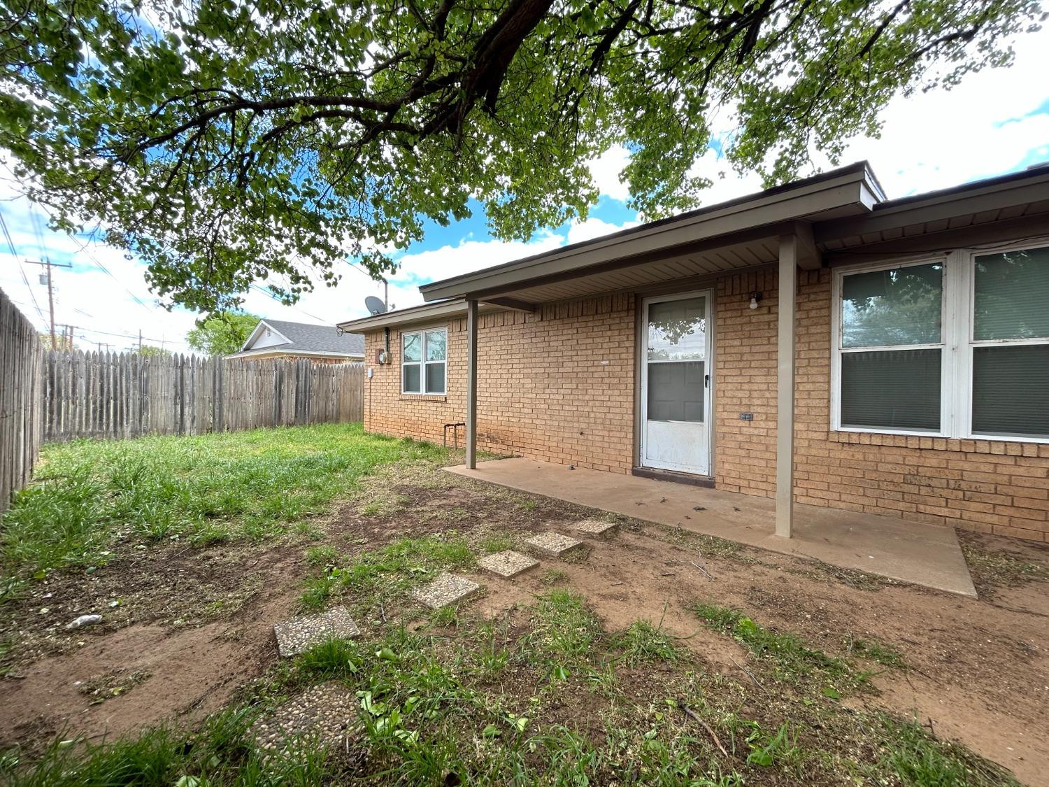 4812 66th Street, Unit B Lubbock, TX 79414 - Photo 9 of 9 a house that has a tree in front of the house