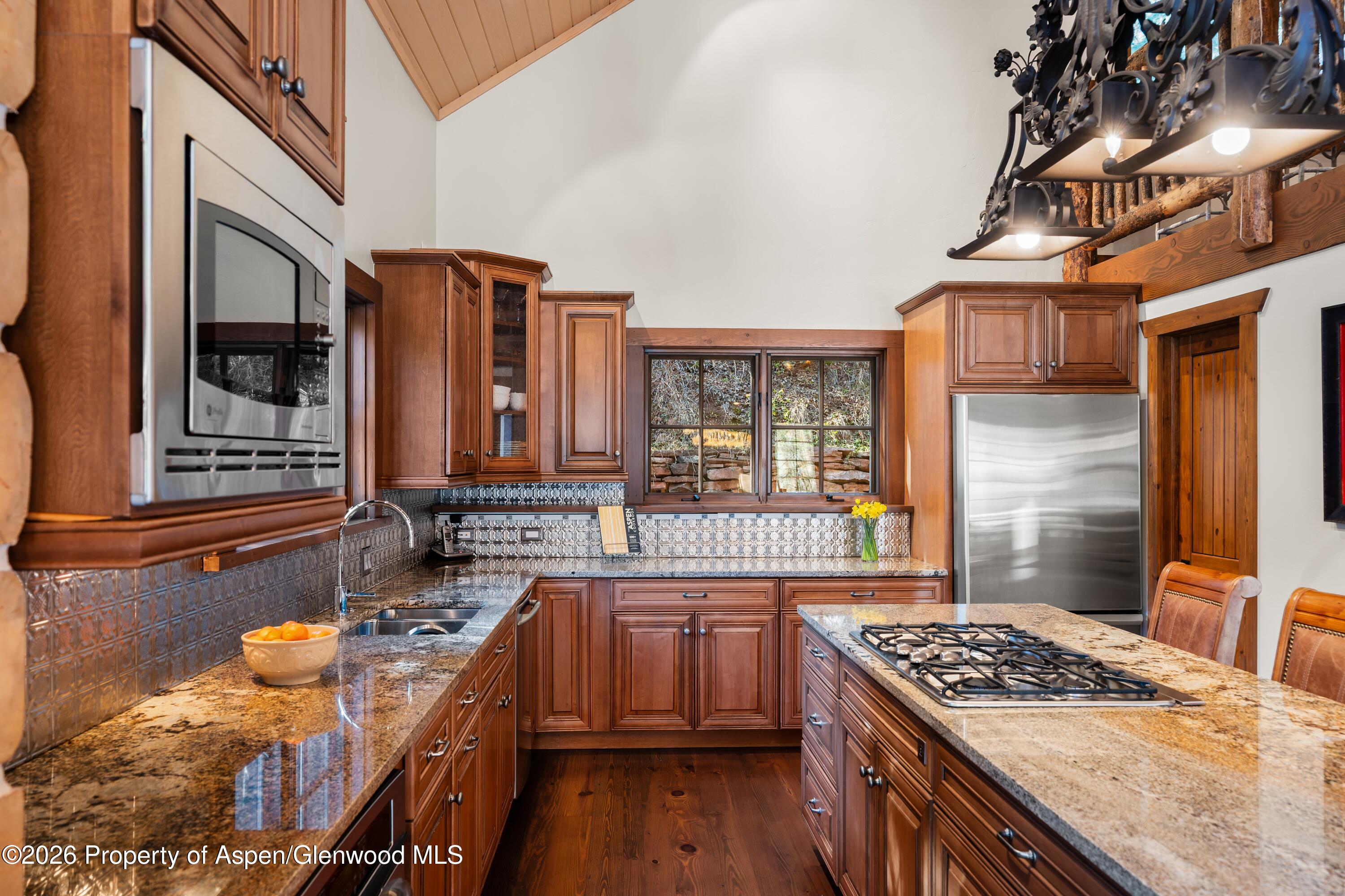 397 Oak Road Basalt, CO 81621 - Photo 13 of 32 a kitchen with stainless steel appliances granite countertop a stove a sink and a refrigerator