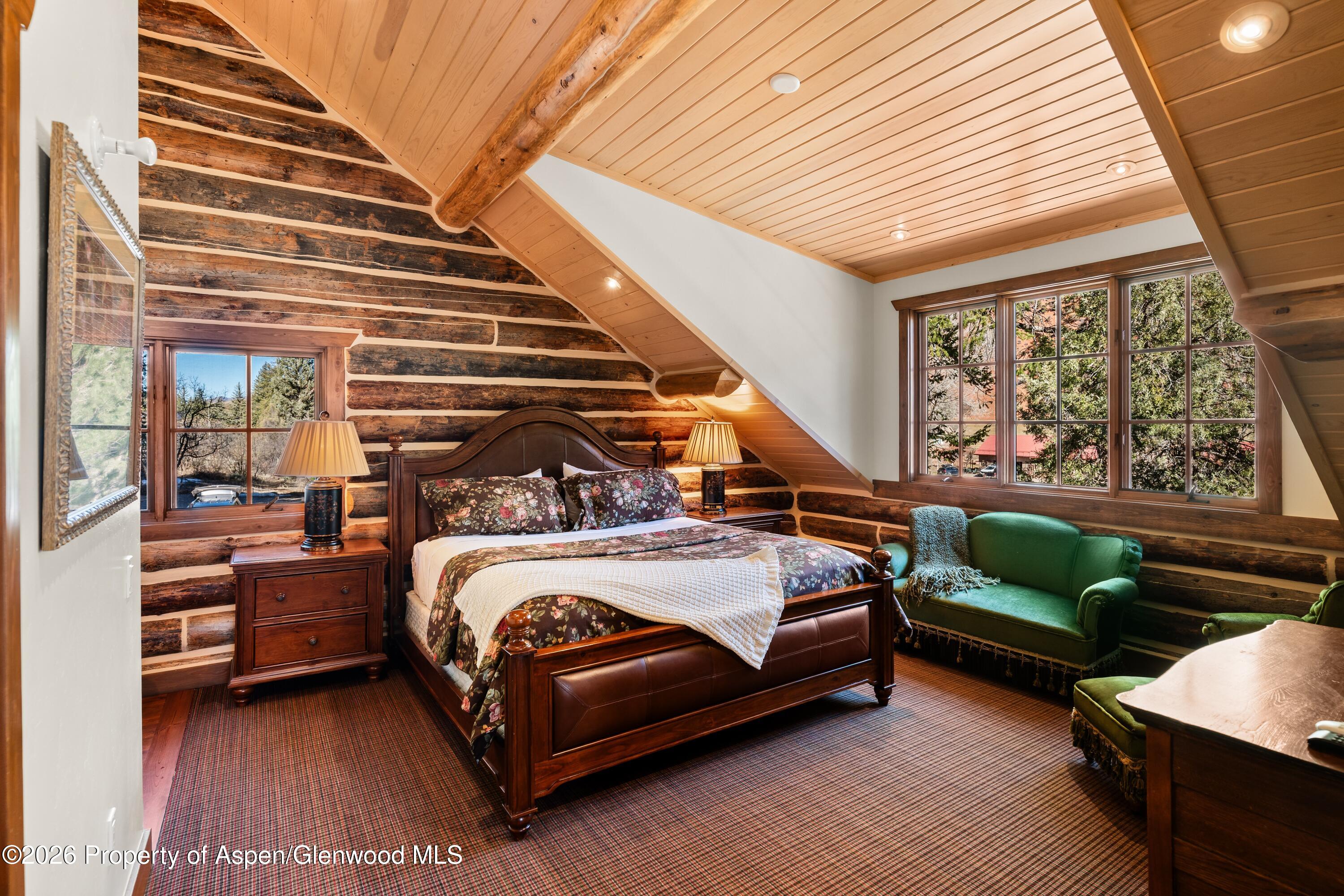 397 Oak Road Basalt, CO 81621 - Photo 14 of 32 a bedroom with furniture and a large window