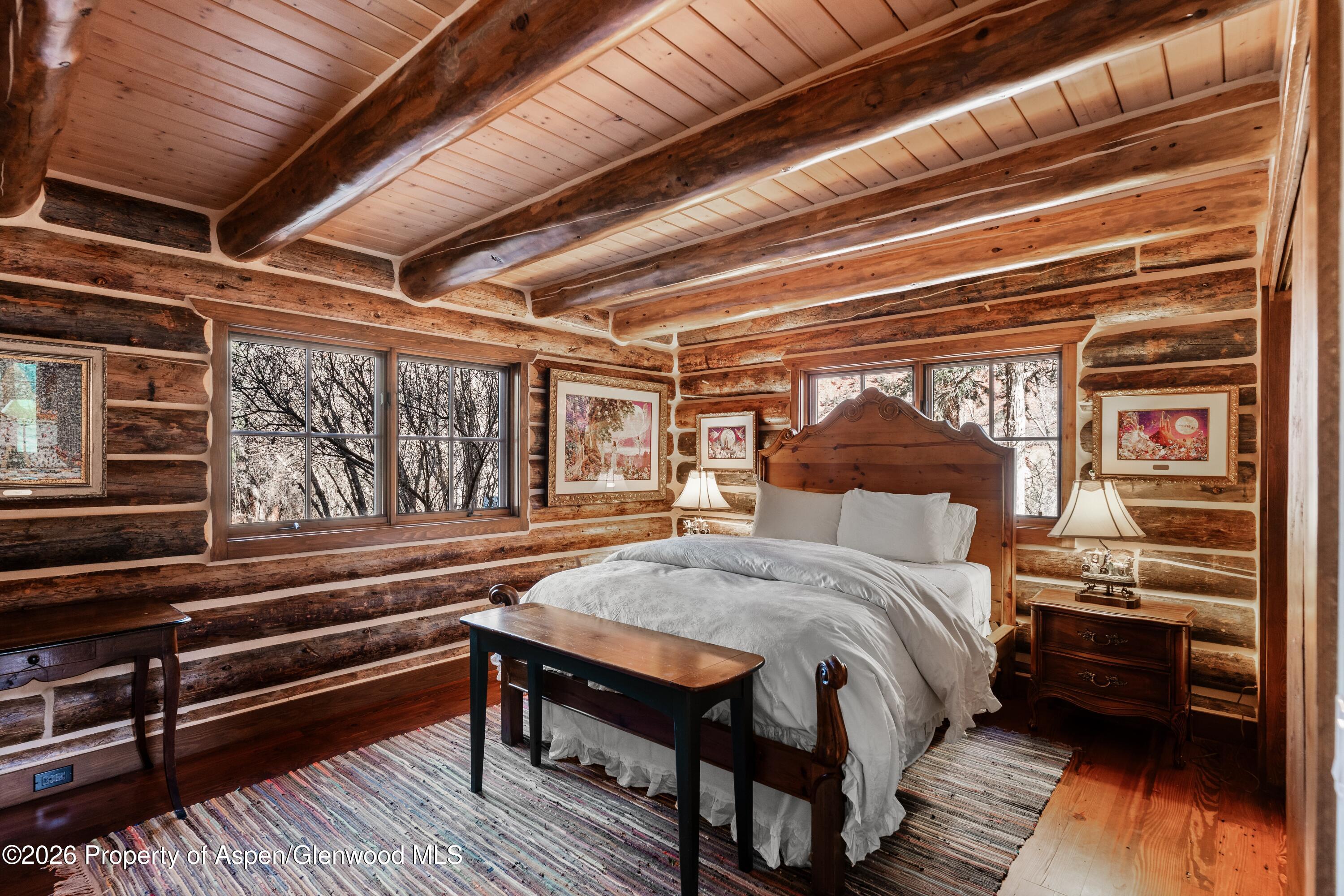 397 Oak Road Basalt, CO 81621 - Photo 17 of 32 a bed sitting in a bedroom next to a window