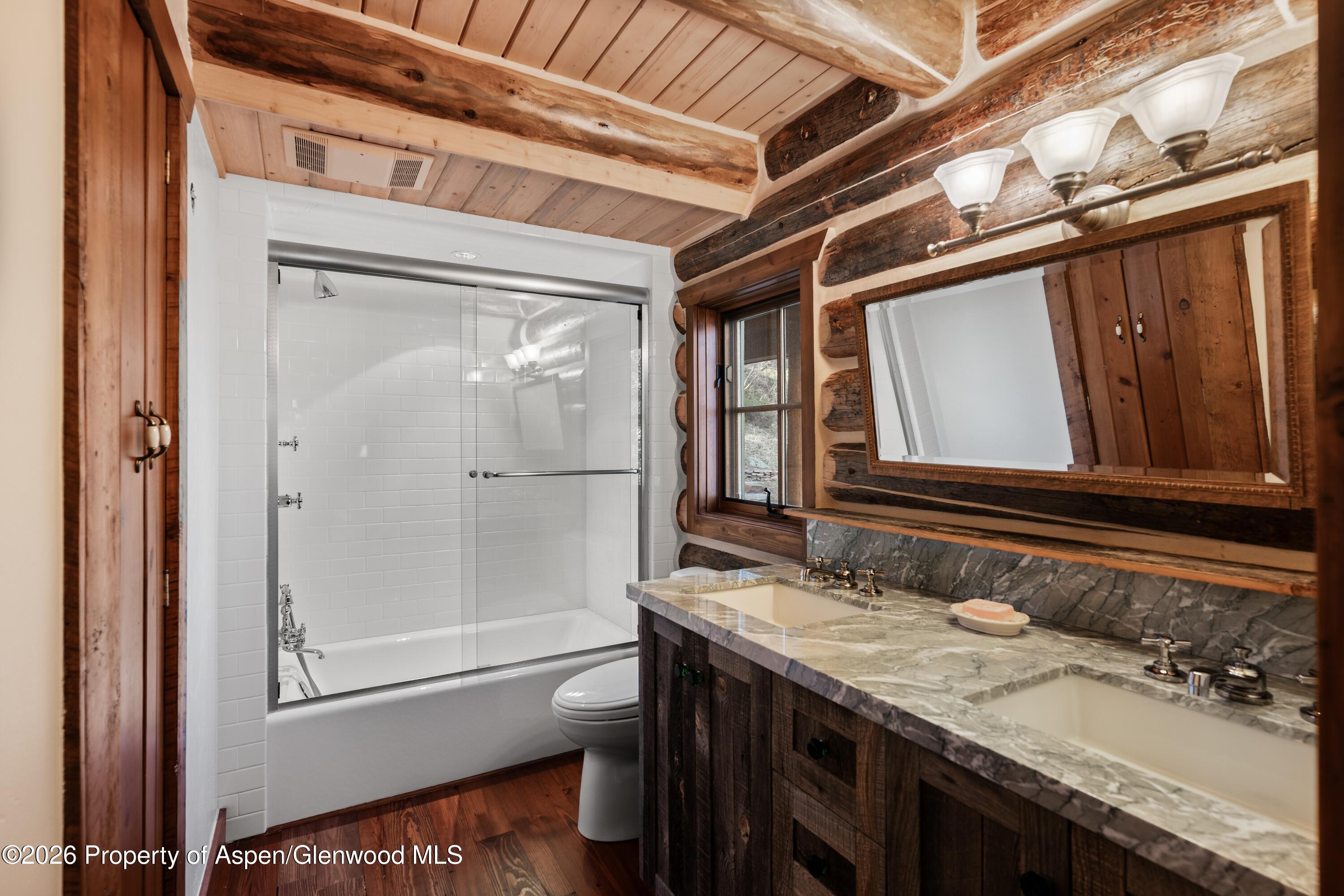 397 Oak Road Basalt, CO 81621 - Photo 18 of 32 a bathroom with a granite countertop sink a mirror and shower