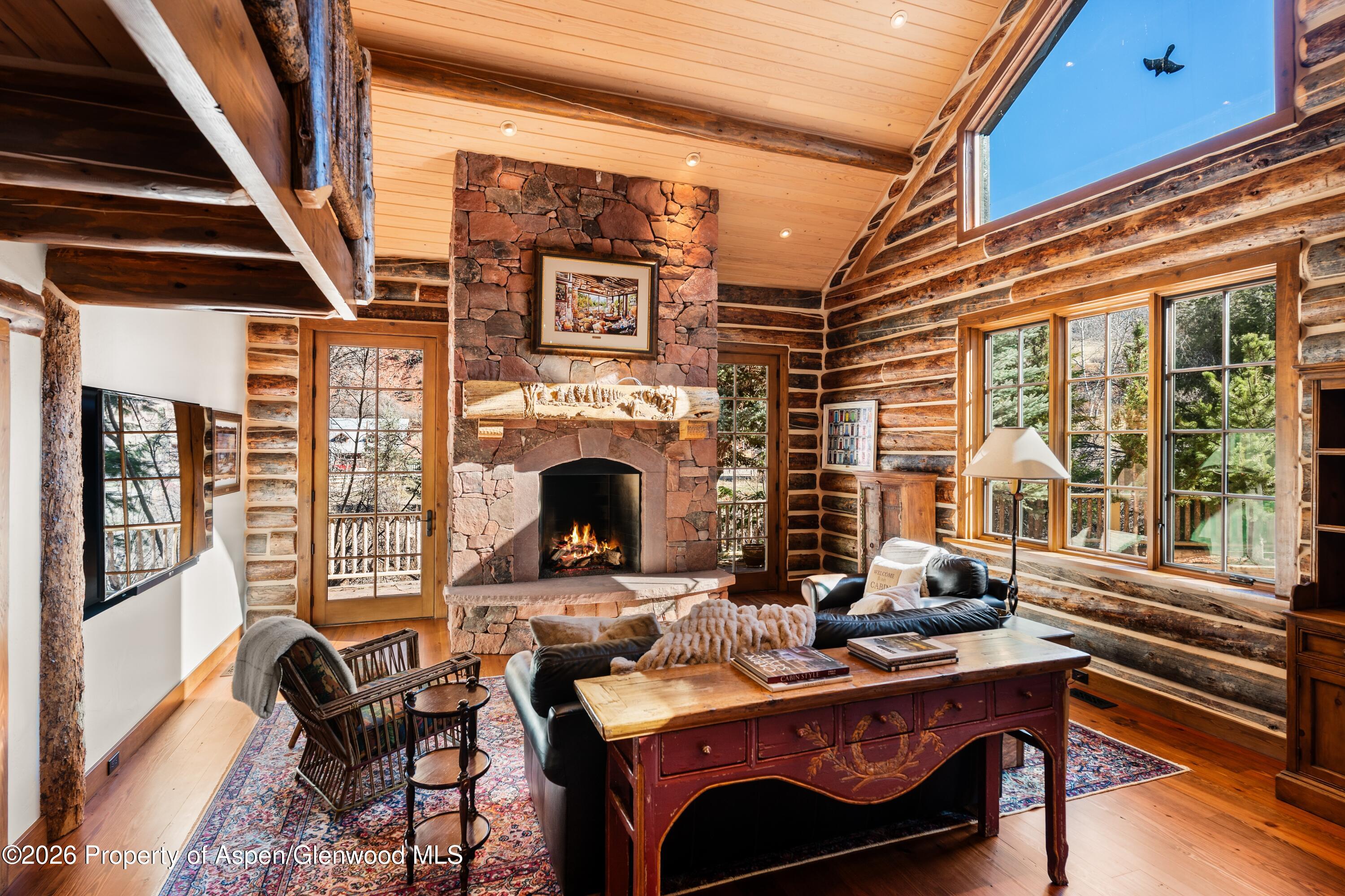 397 Oak Road Basalt, CO 81621 - Photo 5 of 32 a living room with furniture a fireplace and a floor to ceiling window