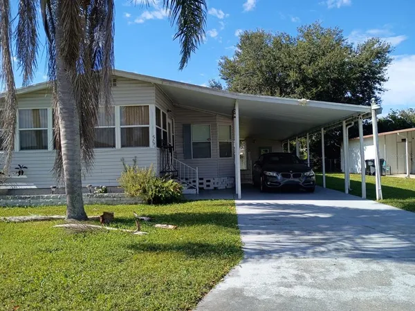 a view of a house with backyard porch and sitting area