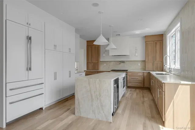 a kitchen with granite countertop white cabinets and white appliances