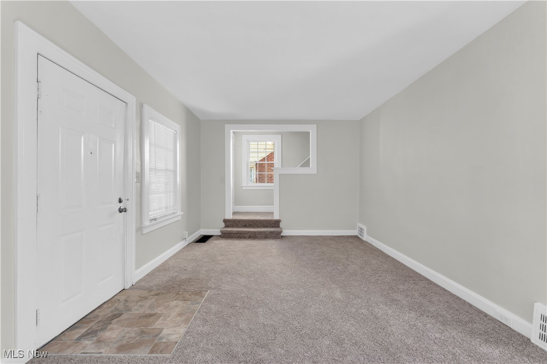 945 Nela View Road Cleveland Heights, OH 44112 - Photo 7 of 27 Entrance foyer featuring light carpet and stone finish floors
