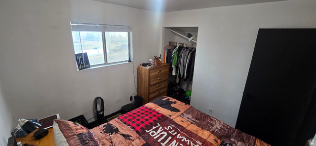 47 Larson Road Vernon, UT 84080 - Photo 7 of 34 Room featuring a single window with blinds, a built-in closet with hanging rod, and a black interior door