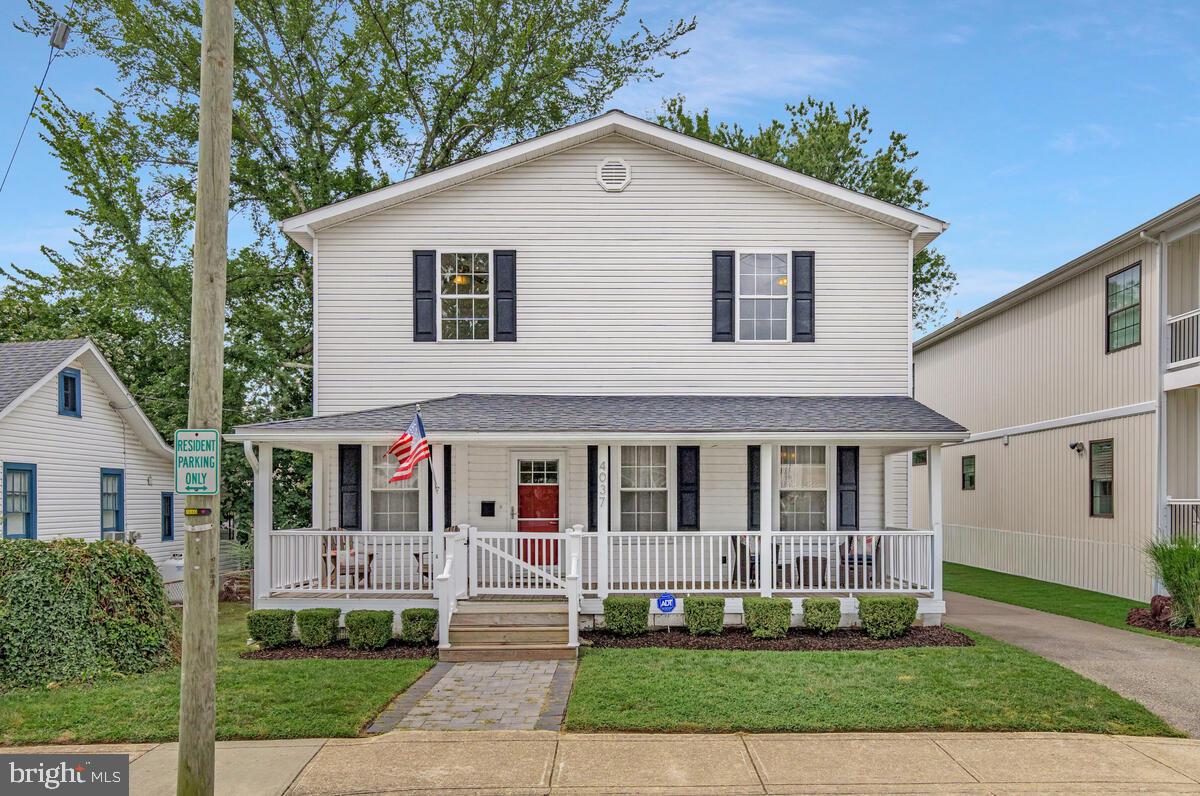 4037 7th Street North Beach, MD 20714 - Photo 16 of 54 a front view of a house with a yard