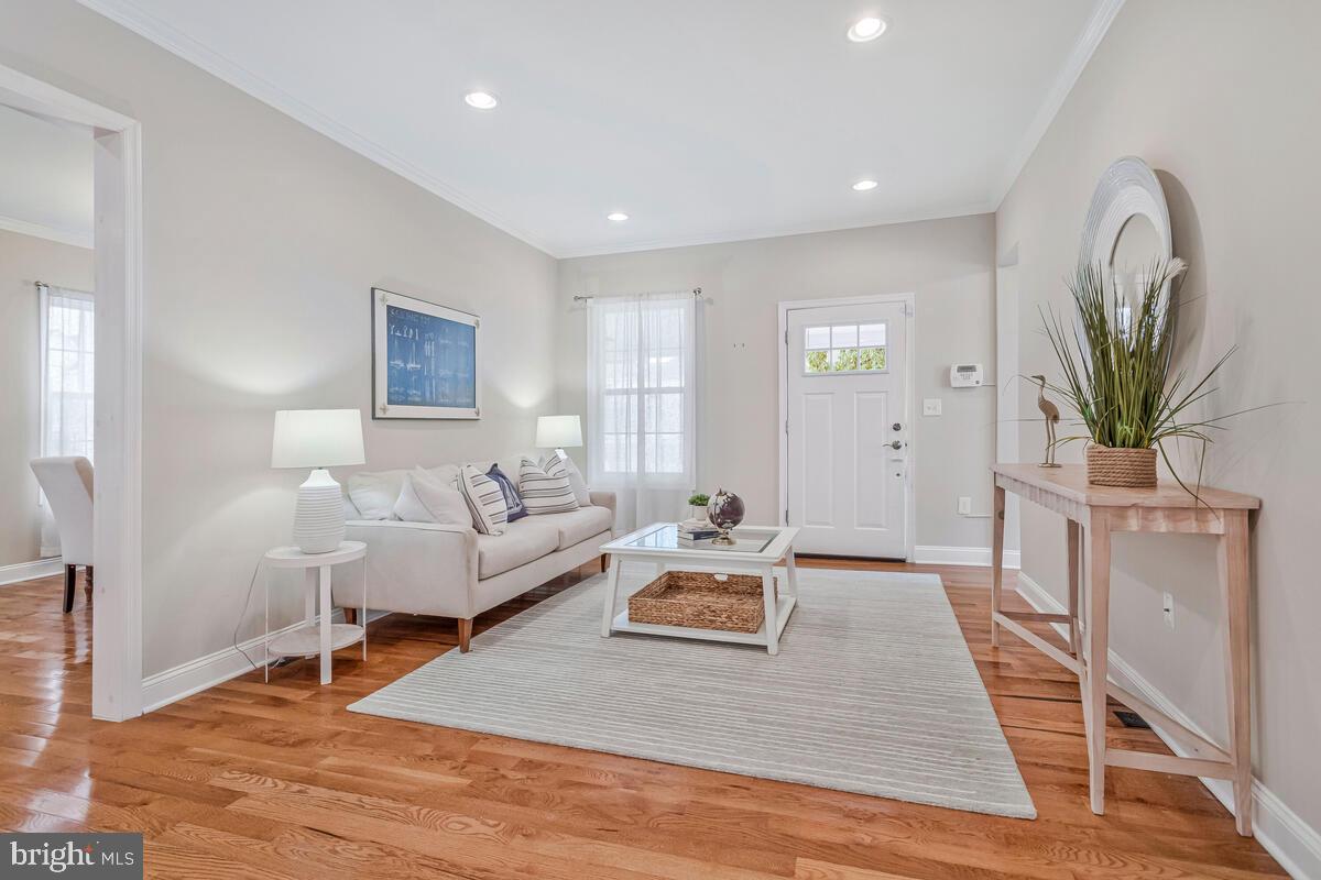 4037 7th Street North Beach, MD 20714 - Photo 19 of 54 a living room with furniture a wooden floor and a potted plant