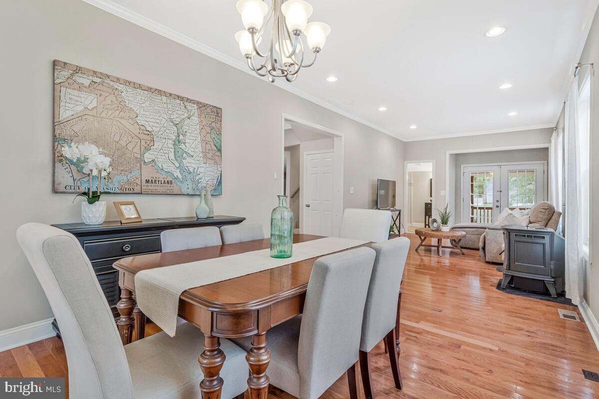 4037 7th Street North Beach, MD 20714 - Photo 24 of 54 a view of a dining room with furniture wooden floor and a chandelier