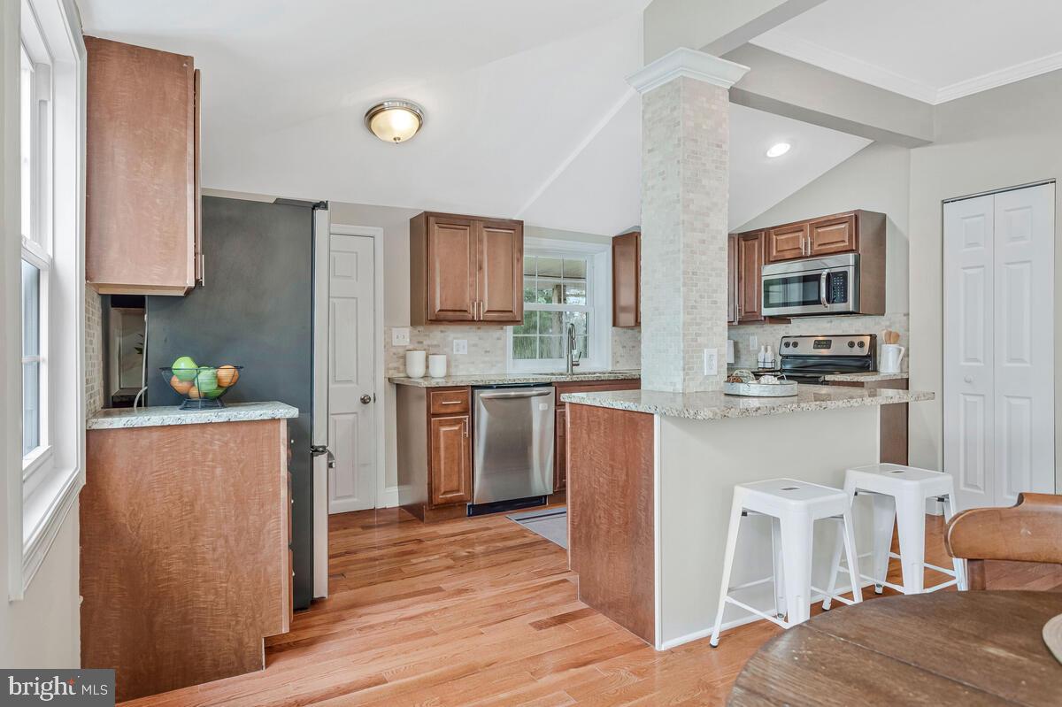 4037 7th Street North Beach, MD 20714 - Photo 27 of 54 a kitchen with stainless steel appliances granite countertop a refrigerator sink and stove