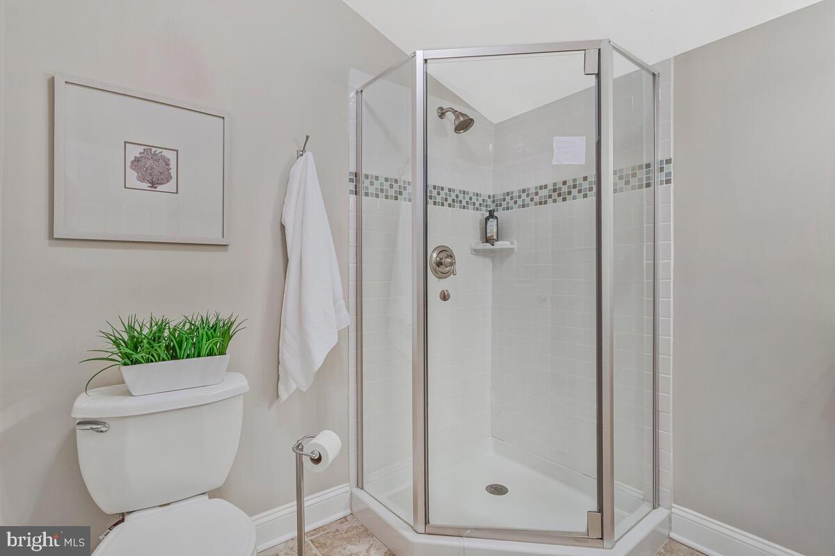 4037 7th Street North Beach, MD 20714 - Photo 33 of 54 a bathroom with a toilet and a shower