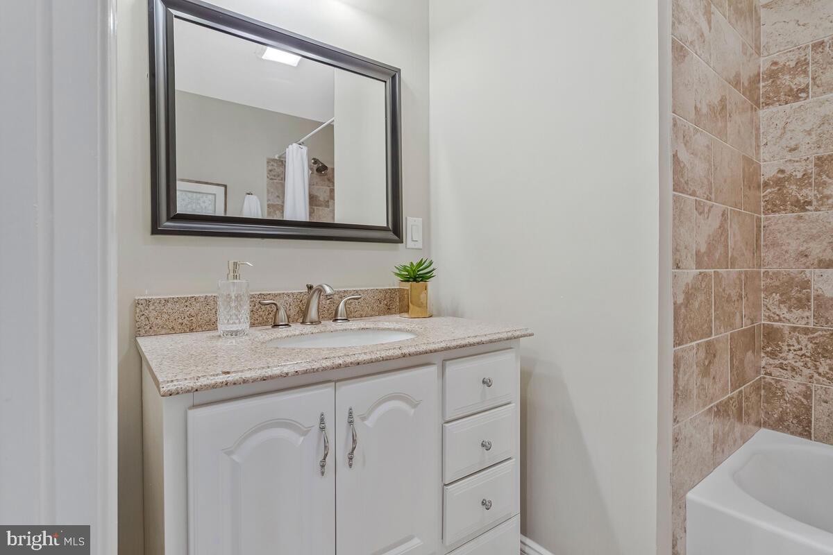 4037 7th Street North Beach, MD 20714 - Photo 47 of 54 a bathroom with a sink vanity and a mirror