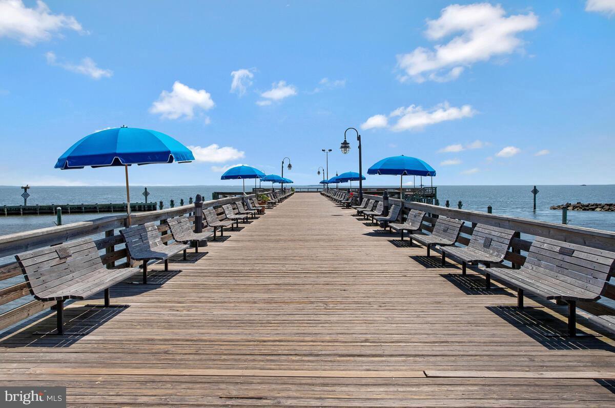4037 7th Street North Beach, MD 20714 - Photo 5 of 54 a view of a patio with chairs and umbrellas on a wooden floor