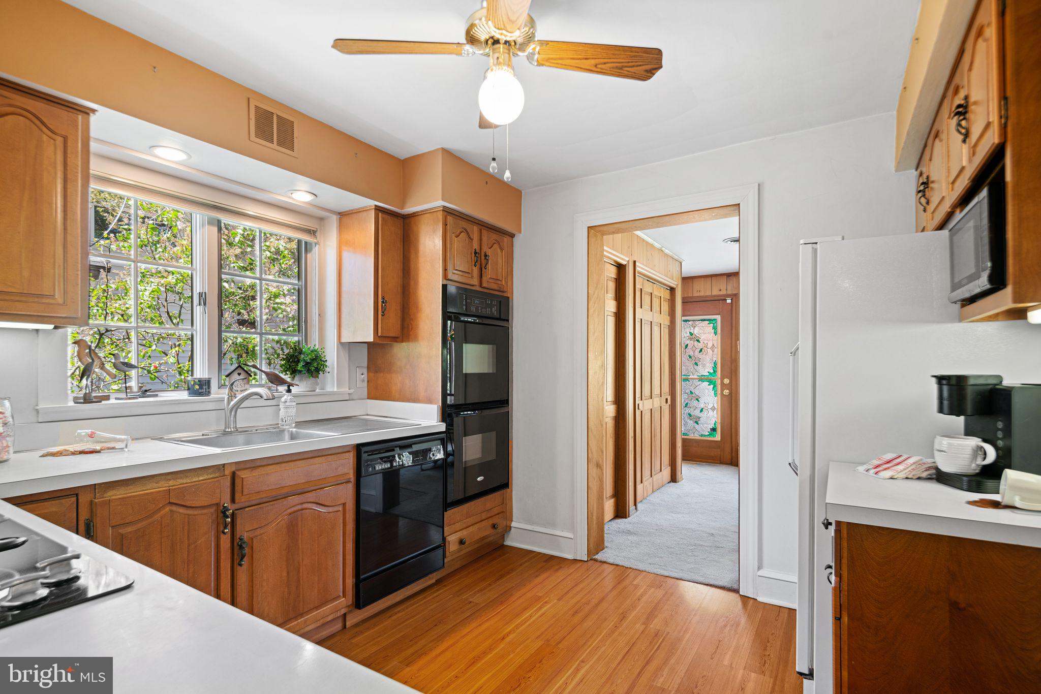 223 Hopkins Road Haddonfield, NJ 08033 - Photo 12 of 51 a kitchen with stainless steel appliances granite countertop a sink cabinets and wooden floor