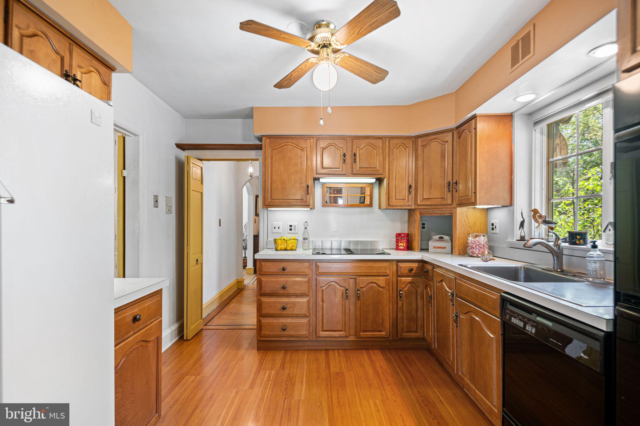 223 Hopkins Road Haddonfield, NJ 08033 - Photo 13 of 51 a kitchen with stainless steel appliances a sink a stove a refrigerator cabinets and a window