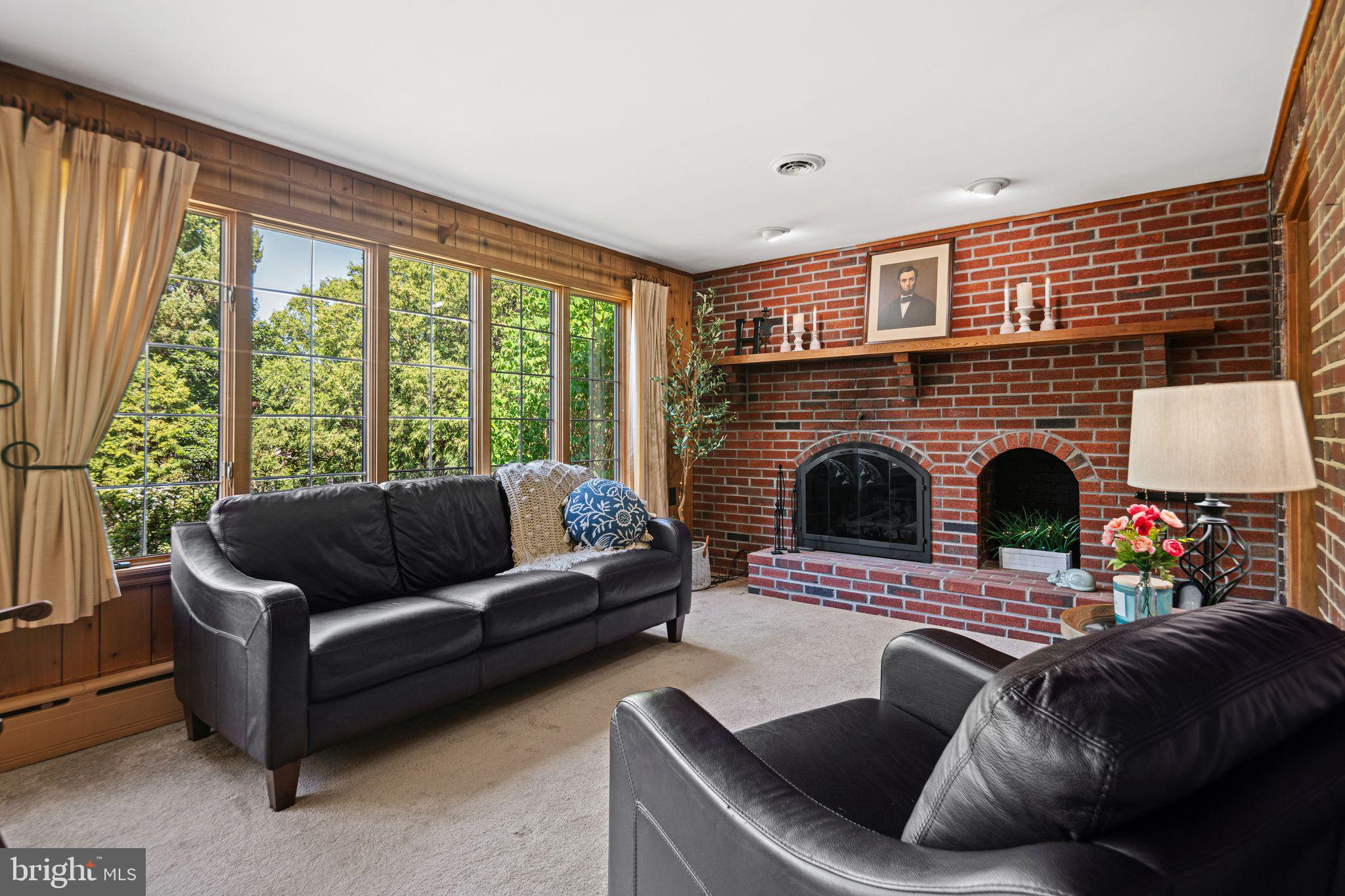 223 Hopkins Road Haddonfield, NJ 08033 - Photo 19 of 51 a living room with furniture a fireplace and a large window