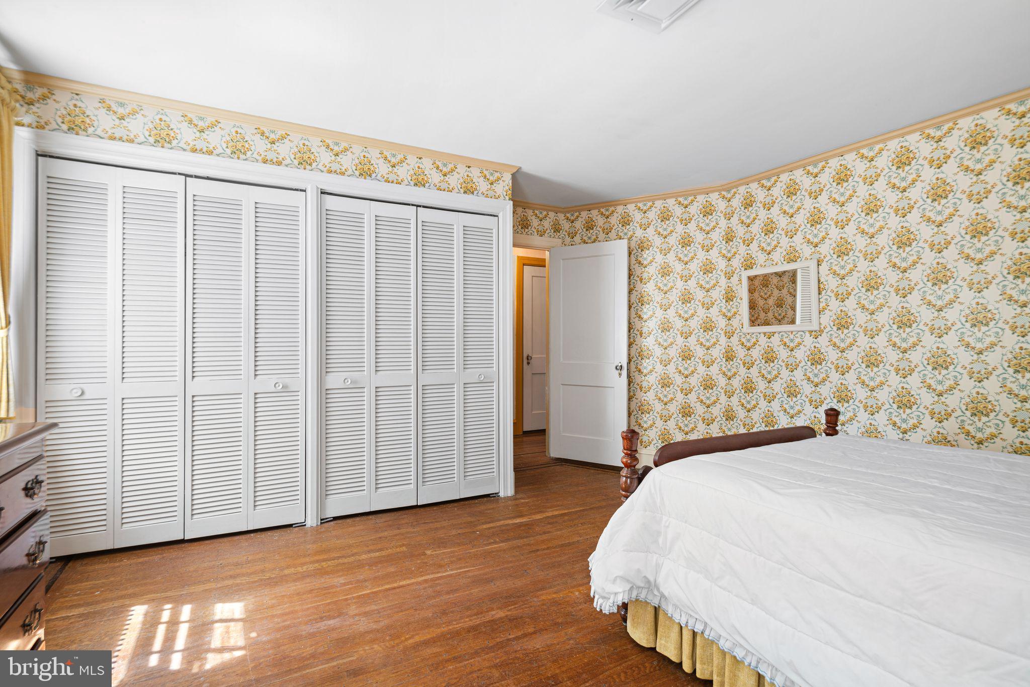 223 Hopkins Road Haddonfield, NJ 08033 - Photo 24 of 51 a bedroom with a bed and wooden floor
