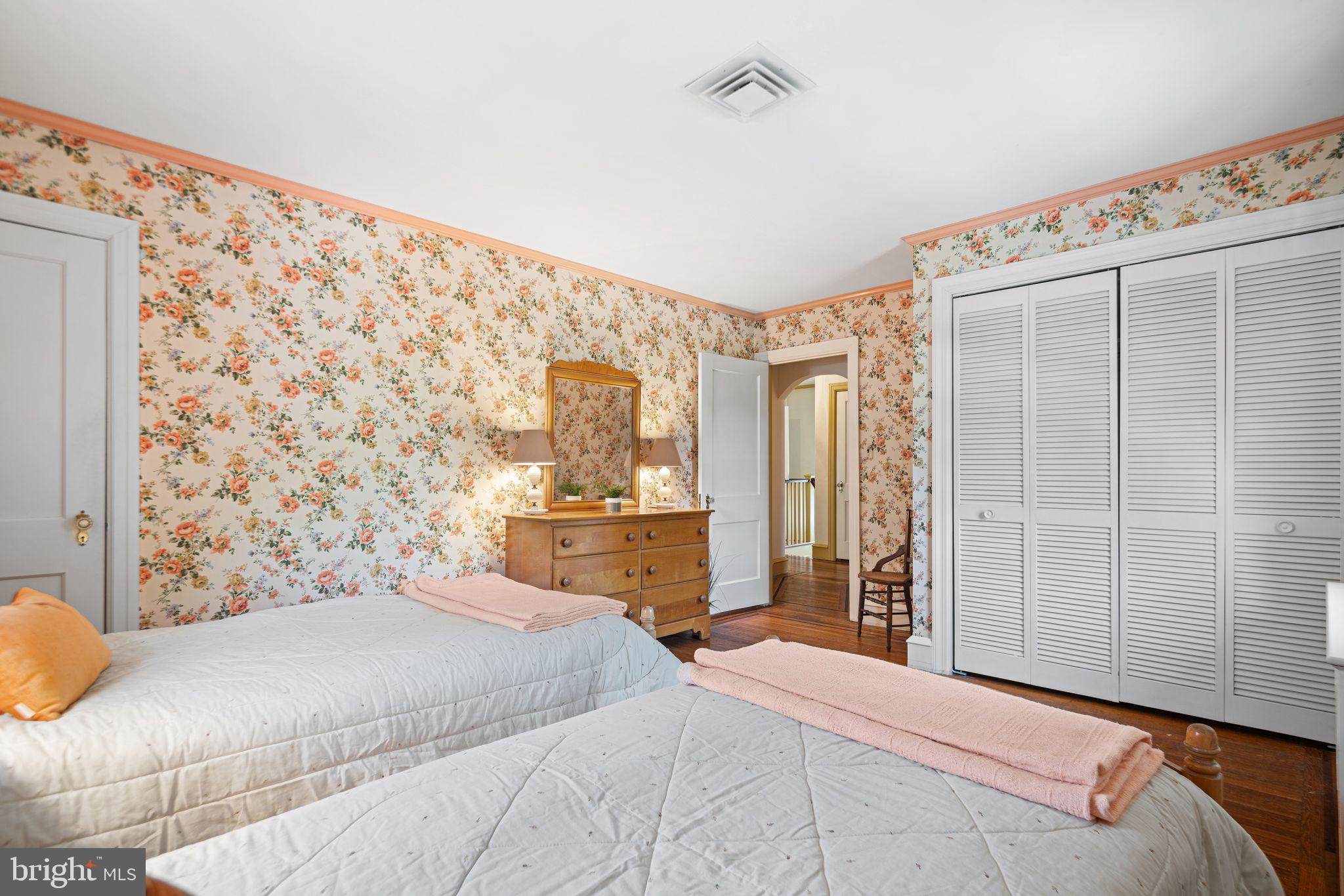 223 Hopkins Road Haddonfield, NJ 08033 - Photo 31 of 51 a bedroom with a large bed and a chandelier