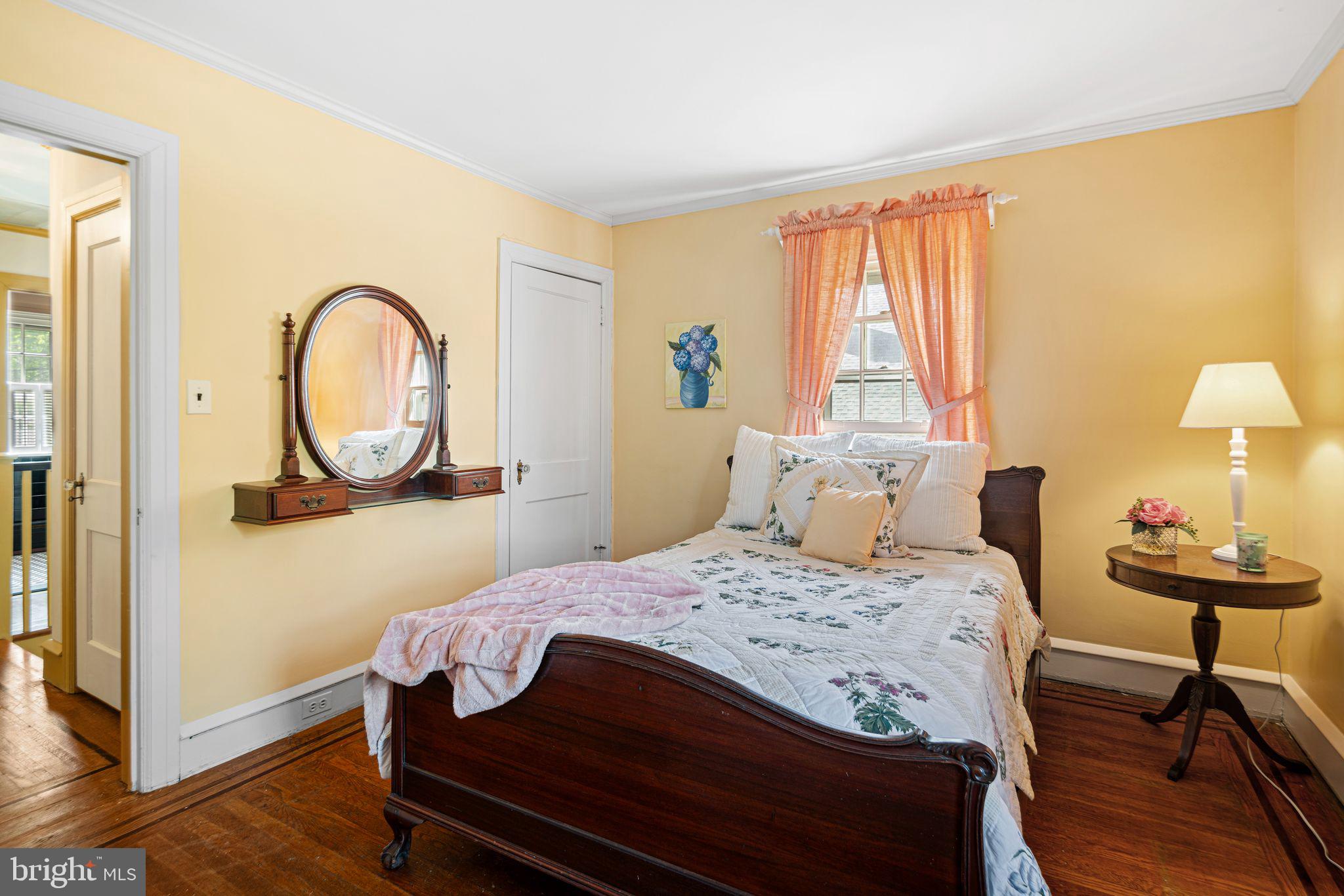 223 Hopkins Road Haddonfield, NJ 08033 - Photo 35 of 51 a bedroom with a bed a mirror and a window
