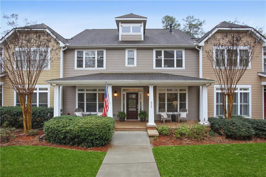 Welcome Home! Picture yourself enjoying your morning coffee on this spacious covered porch, overlooking the serene green space. 
