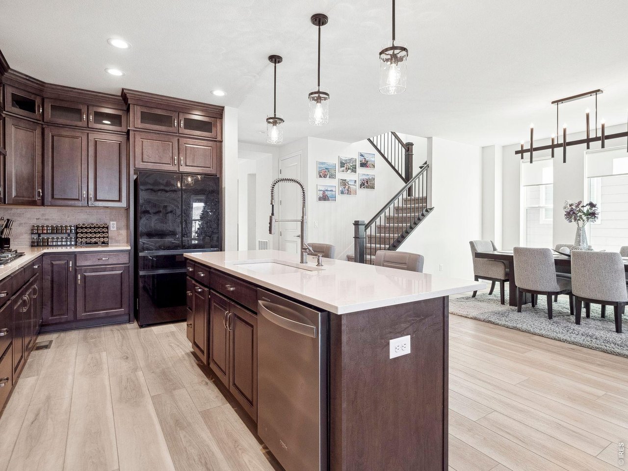 3051 Newfound Lk Road Berthoud, CO 80513 - Photo 12 of 36 a kitchen with kitchen island a counter top space a sink a stove and wooden floor