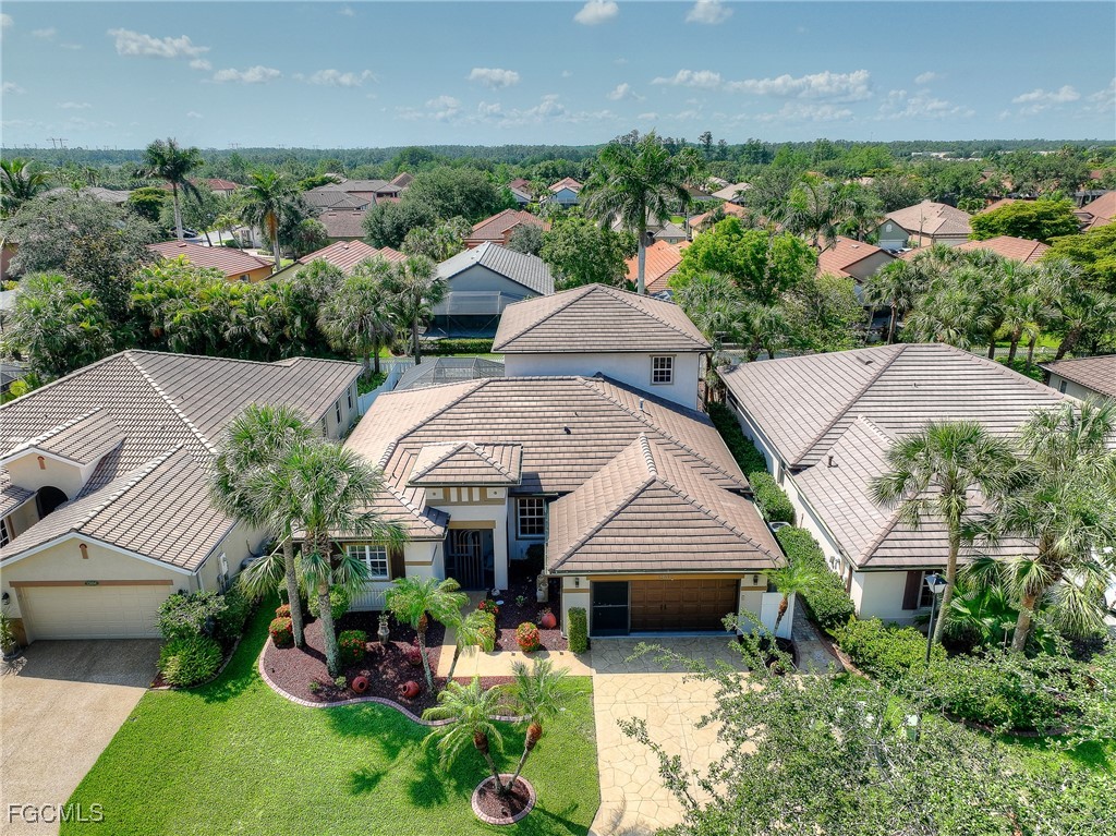 12890 Timber Ridge Drive Fort Myers, FL 33913 - Photo 1 of 39 an aerial view of a house with a garden and plants