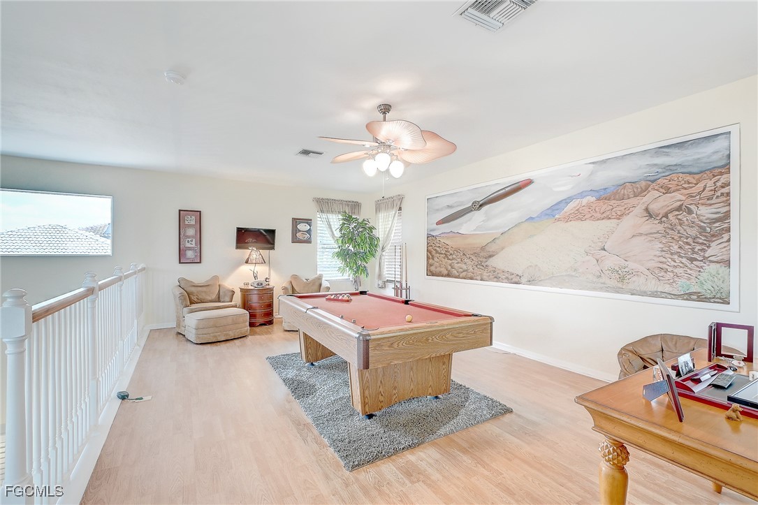 12890 Timber Ridge Drive Fort Myers, FL 33913 - Photo 15 of 39 a living room with furniture a chandelier and a rug