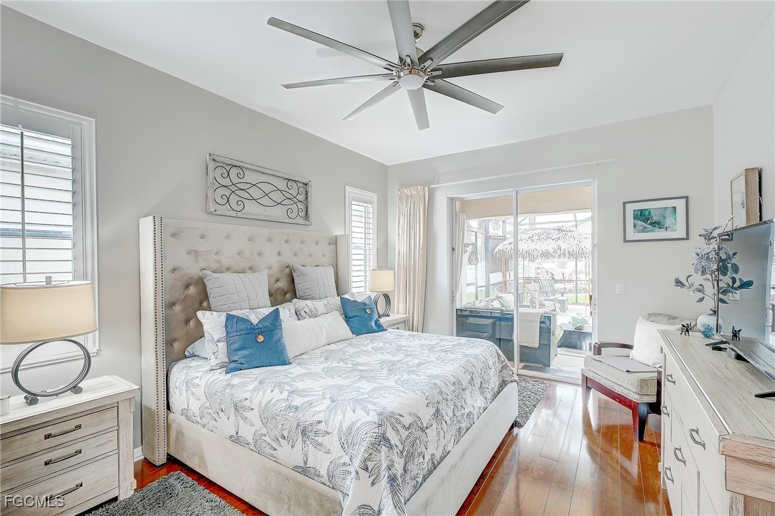12890 Timber Ridge Drive Fort Myers, FL 33913 - Photo 19 of 39 a bedroom with a bed and wooden floor