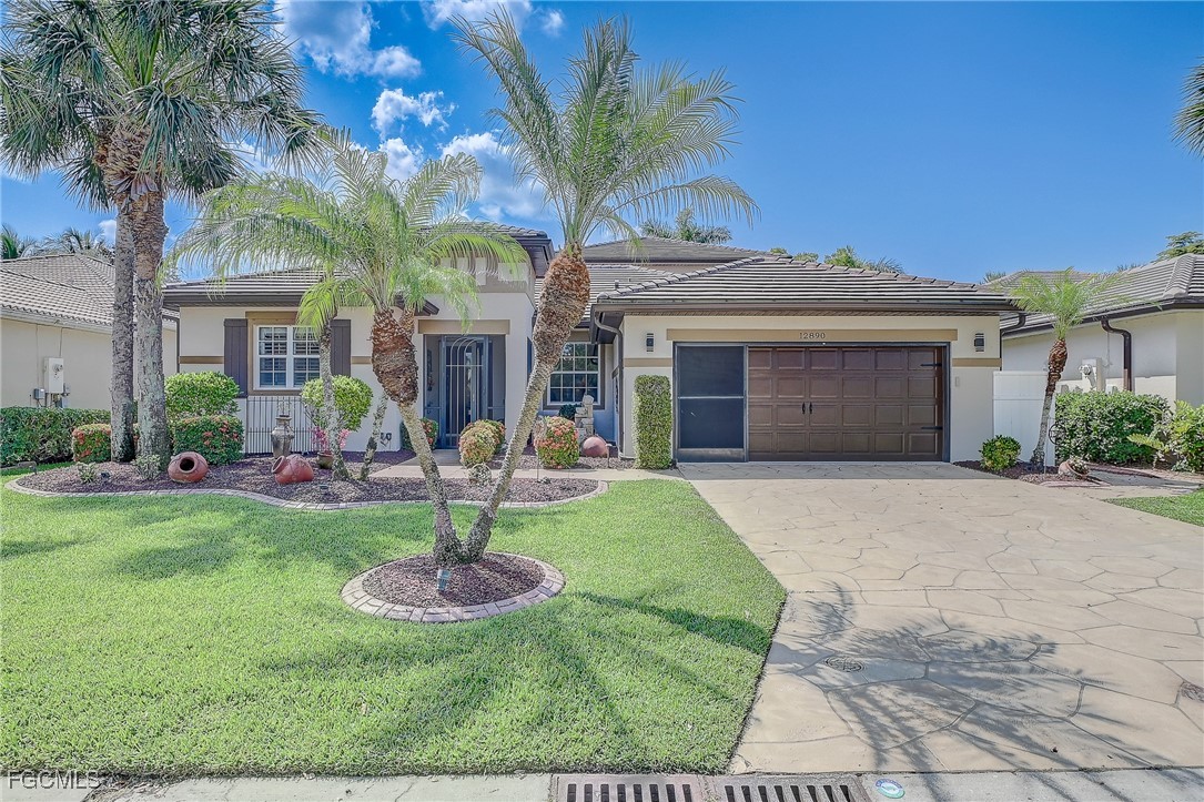 12890 Timber Ridge Drive Fort Myers, FL 33913 - Photo 2 of 39 a front view of a house with garden and fountain