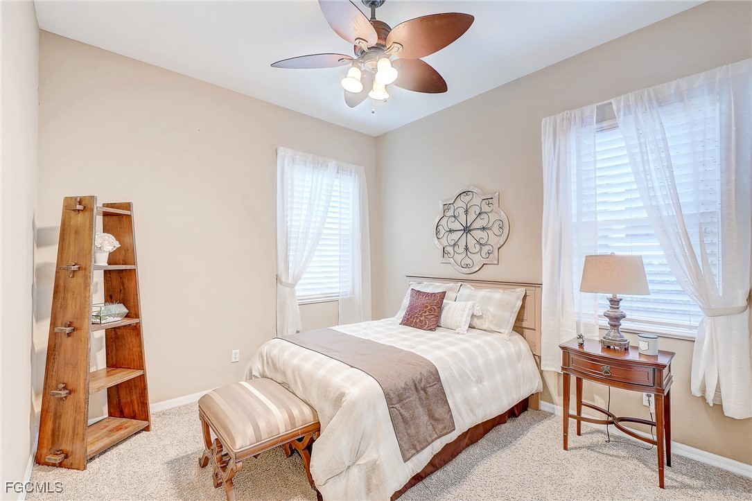 12890 Timber Ridge Drive Fort Myers, FL 33913 - Photo 23 of 39 a bedroom with a bed and a table in it