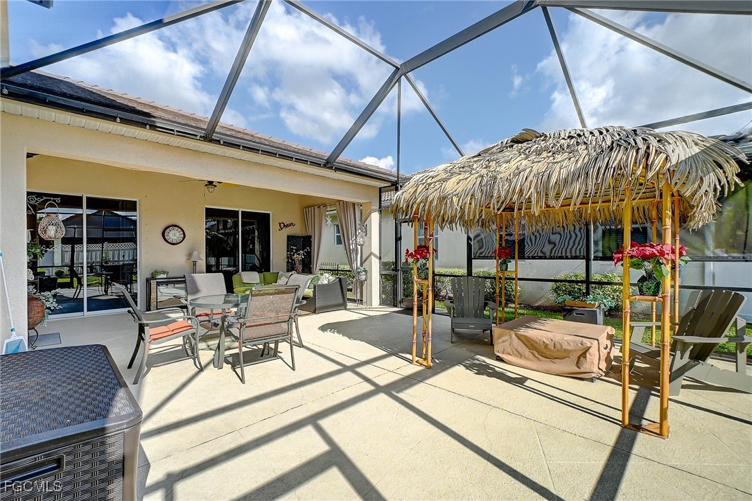 12890 Timber Ridge Drive Fort Myers, FL 33913 - Photo 29 of 39 a view of a patio with table and chairs under an umbrella